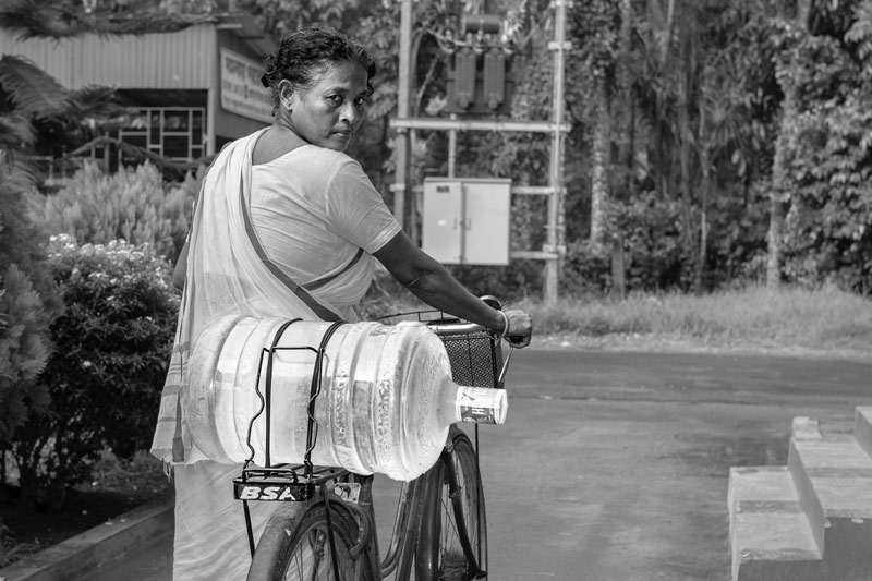 Chhaya Rani Mondal, from Gobardanga municipality, heading home with a 20 liters jar procured from the Sulabh plant in Madhusudankati village, North 24 Parganas district, West Bengal